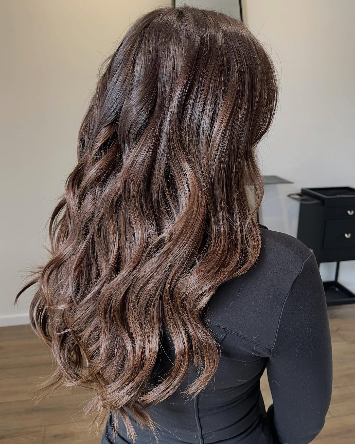 Long rich brunette hair extensions with dimensional soft waves, styled by Platinum Hair Extensions in Adelaide.