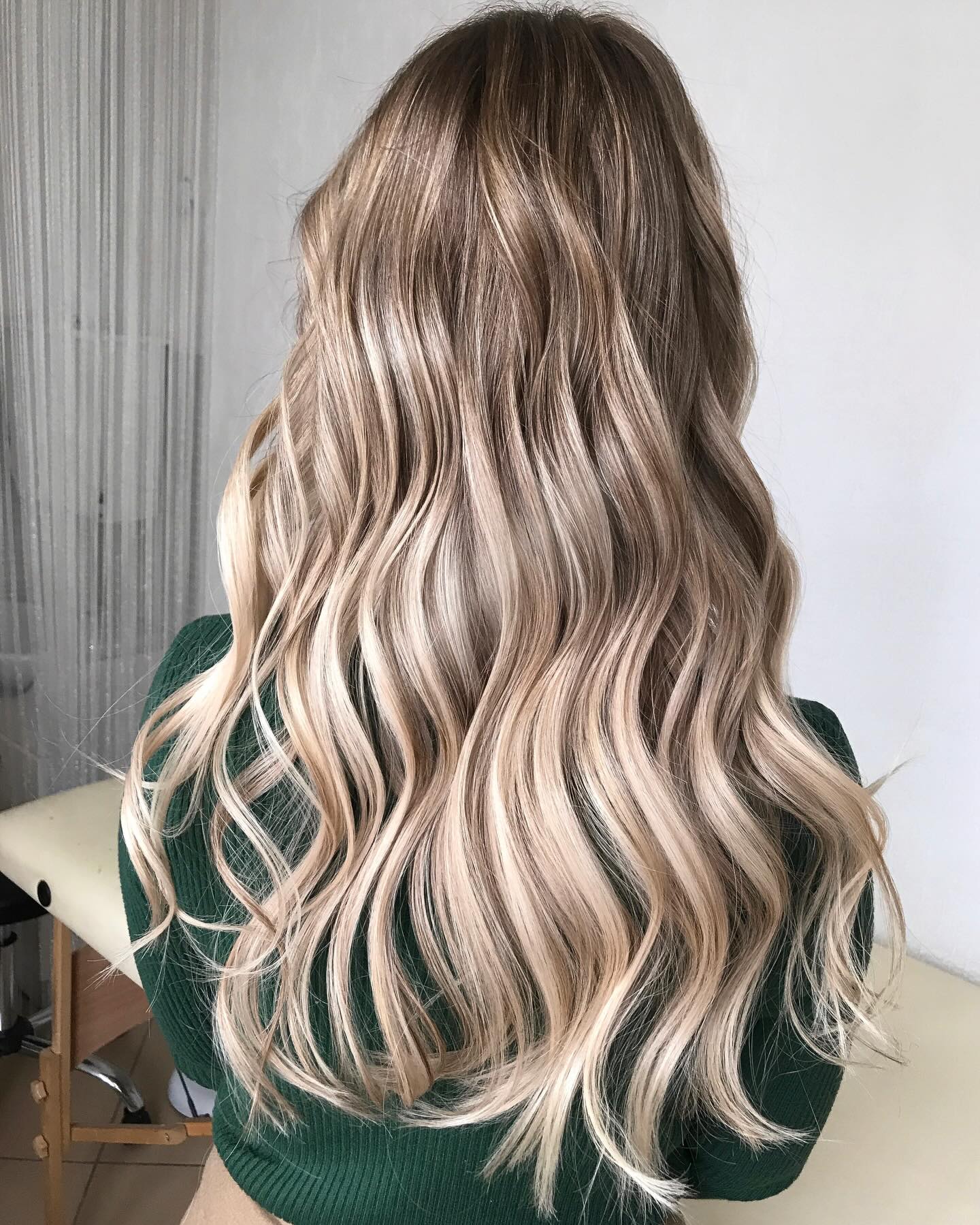 Long dimensional beige and ash blonde hair extensions in soft waves, styled by Platinum Hair Extensions in Adelaide.