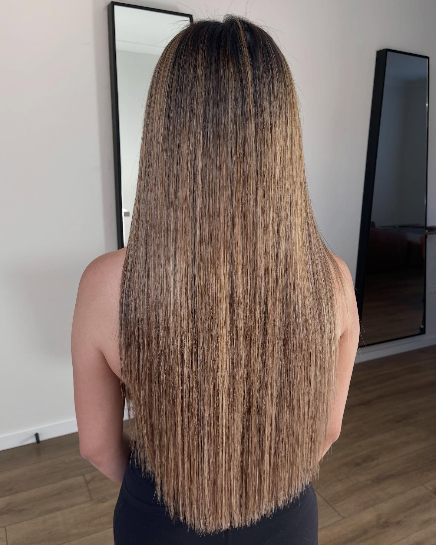 Long neutral bronde hair extensions with a seamless darker root blend, styled by Platinum Hair Extensions in Adelaide.