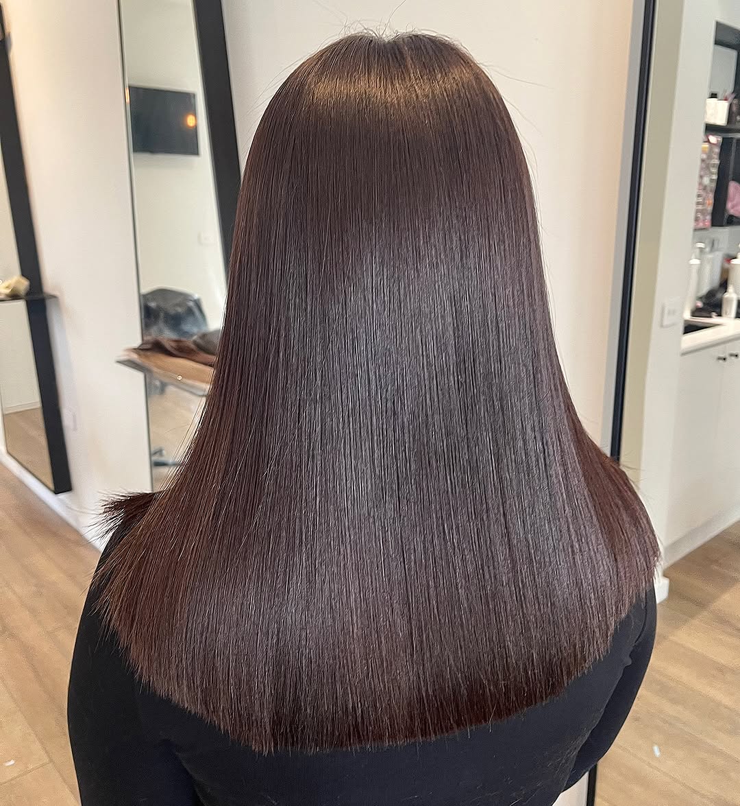 Rich brunette micro bead hair extensions with a glossy finish