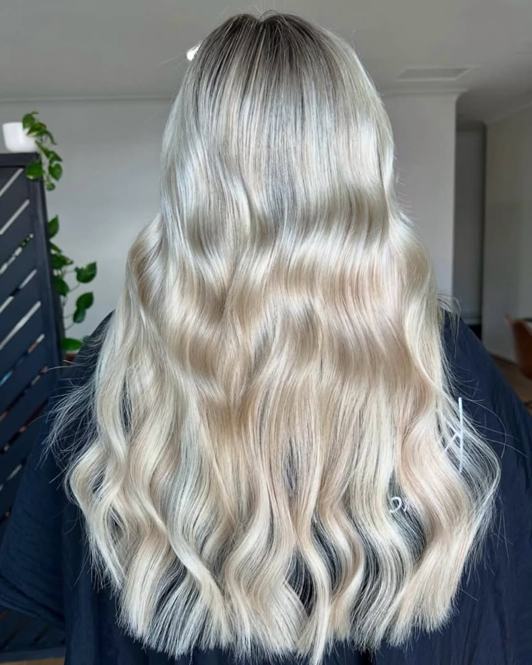 Iced blonde balayage hair extensions styled in soft waves